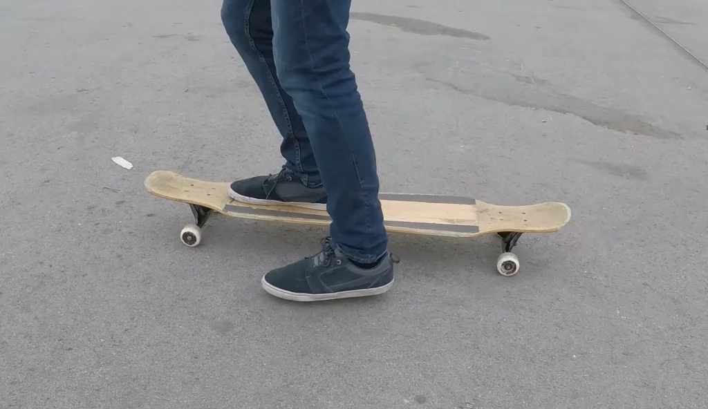 a person starting longboarding