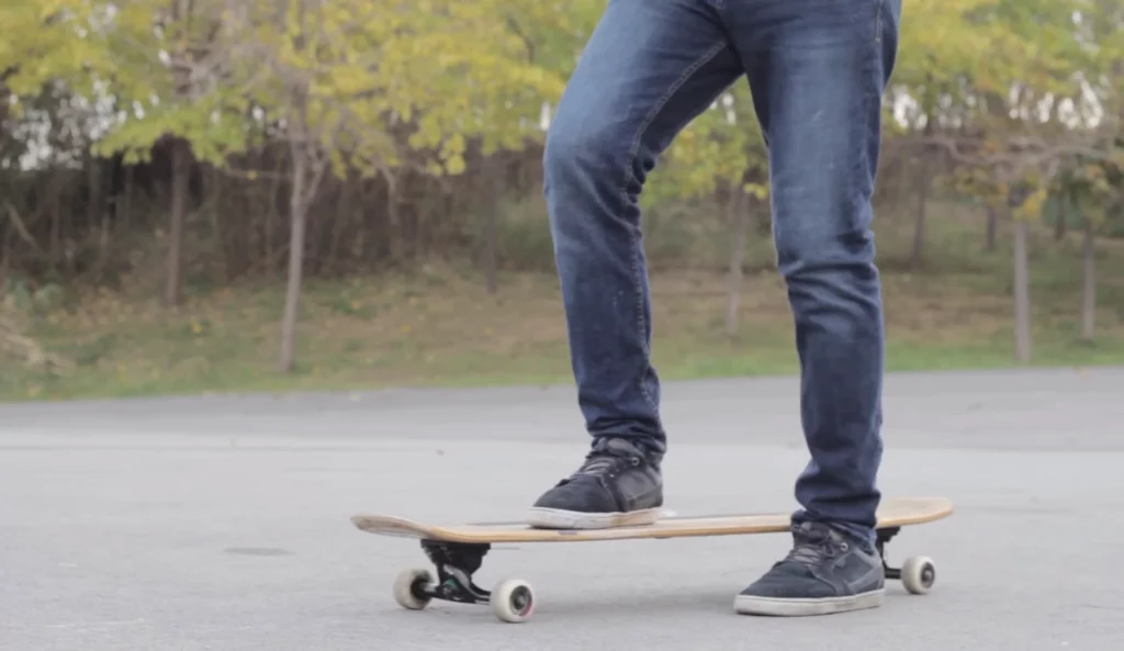 a person doing tricks on a longboard
