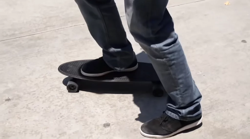 a person riding penny skateboard