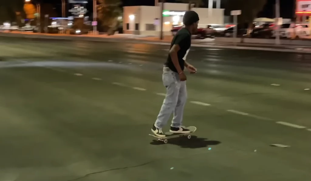 skateboarding on road at night