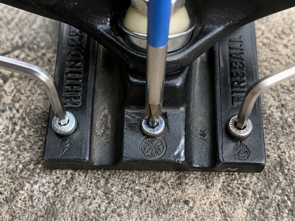 Comparison of Allen vs Phillips skateboard hardware bolts and tools.